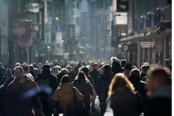Crowd of people walking down a busy street