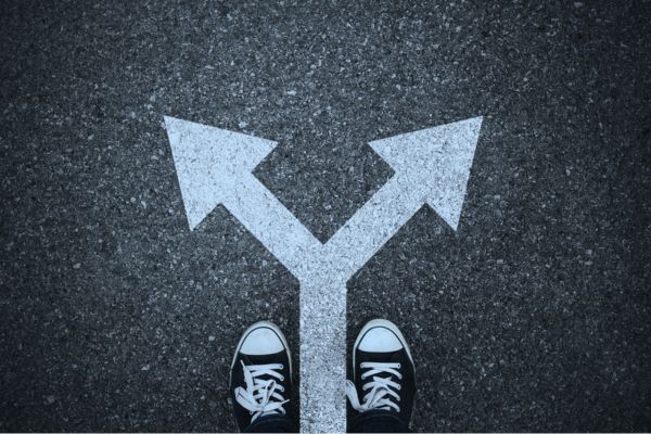 Person standing at a fork in the road