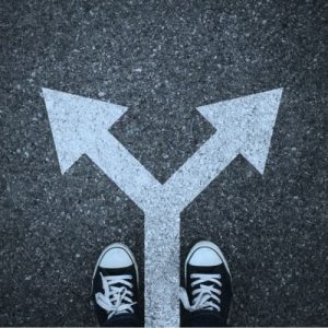 Person standing at a fork in the road