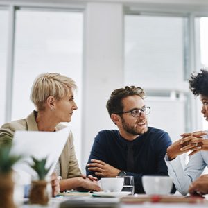 Diverse group of managers meet at a large table